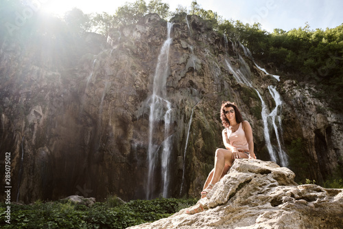 Fototapeta Naklejka Na Ścianę i Meble -  a tourist woman at the Big Waterfall in Plitvice National Park, Croatia - Travel concept