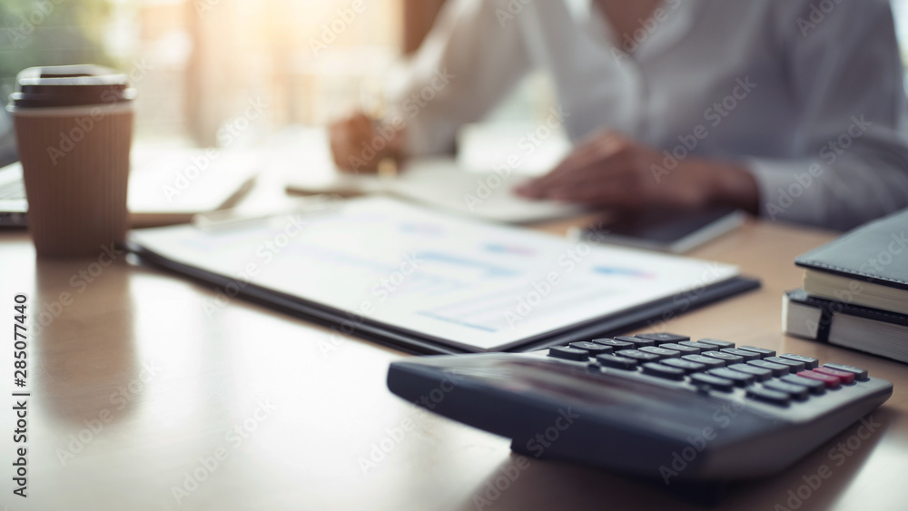 Fototapeta premium Accountant working with data documents calculating on business report, Selective focus.
