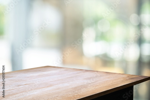 empty wood table with blur montage coffee shop or restaurant background. photo