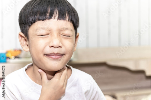 Little boy with sore throat on the bed. healthcare and medical concept.