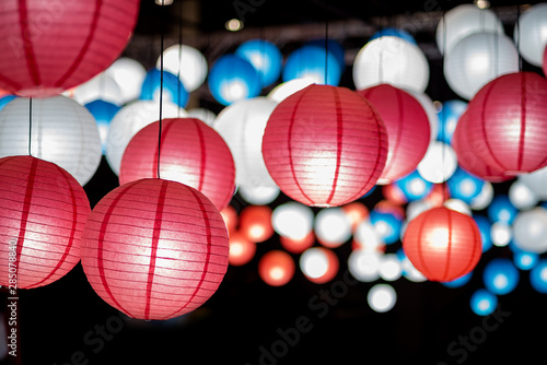 Colorful traditional Japanese paper lantern spread light on the old street ancient town,There are red  blue and white color old lantern,selective focus