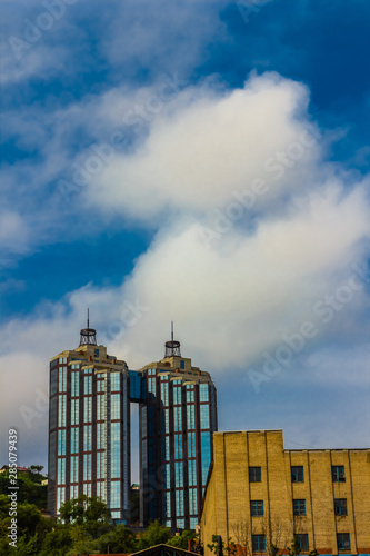 Two identical skyscrapers. Two buildings on a background of blue sky