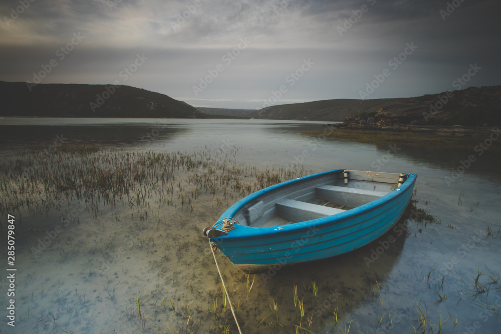 Wide angle landscape image of an old fishing boat in an estuary in South Africa Wide angle landscape image of an old fishing boat in an estuary in South Africa