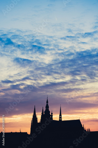Silhouette at sunset of St. Vitus cathedral against the setting Sun from Prague, Czech Republic