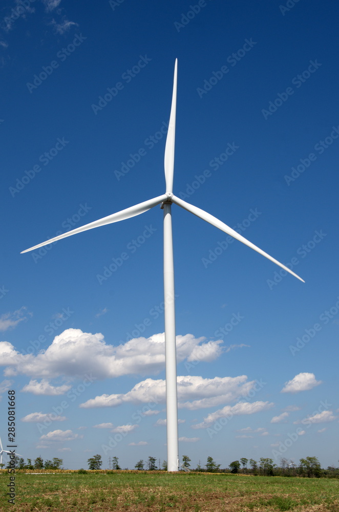 The wind power plant whose blades are located with the famous foreign car sign The wind power plant whose blades are located with the famous foreign car sign
