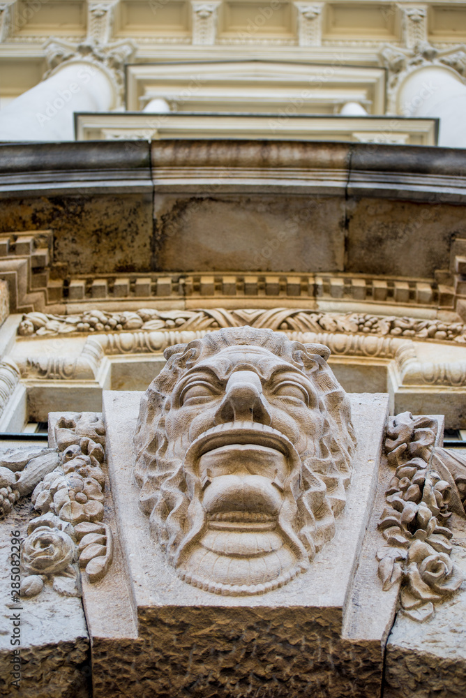 Head sculpture with ornaments on an old building