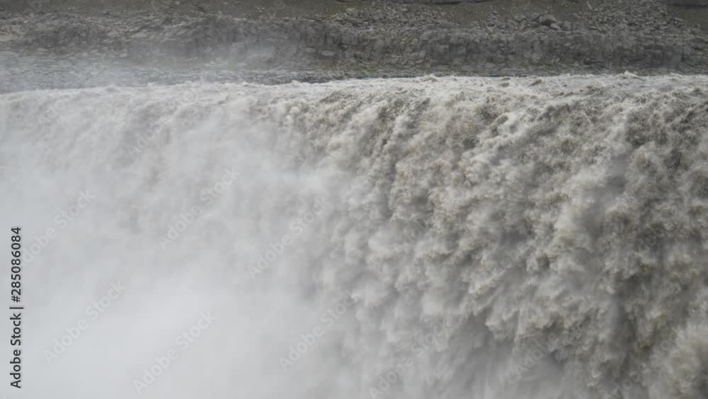 Dettifoss in a cloudy day, a majestic waterfall in Vatnajokull (Vatnajökull) National Park in Northeast Iceland Dettifoss in a cloudy day, a majestic waterfall in Vatnajokull (Vatnajökull) National Park in Northeast Iceland