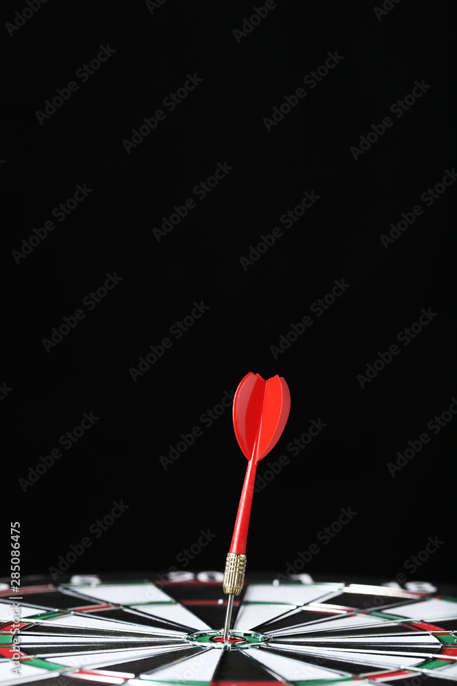 Dartboard with darts on black background Dartboard with darts on black background