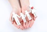 Family figures in female hands on white background