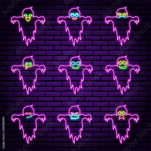 A set of nine neon signs in the form of ghosts, in purple, with different emotions. Against the background of a brick wall. Halloween