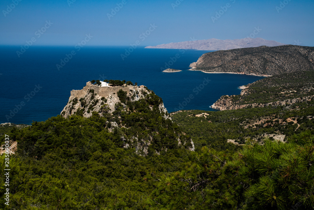 Picturesqueview on Monolithos castle perched atop a 100-meter tall sheer rock face overlooking the Mediterranean