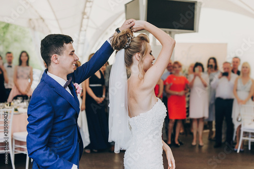 Valokuvatapetti Stylish happy bride and groom gently dancing at wedding reception