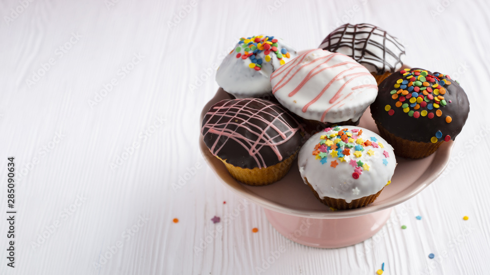 Decorated cupcakes on white table Decorated cupcakes on white table