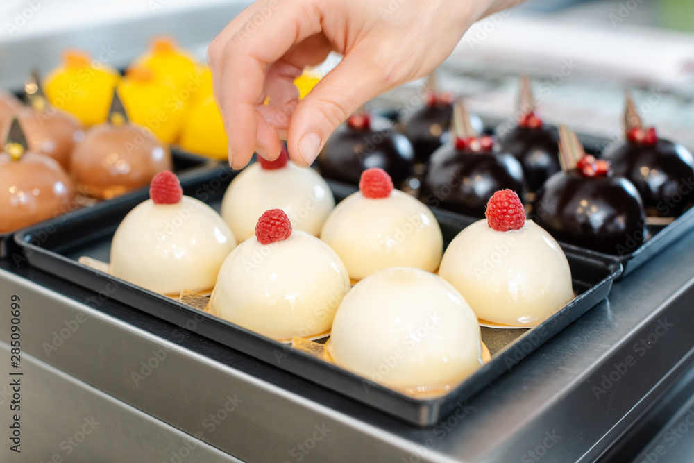 Patissier working on little chocolate desserts Patissier working on little chocolate desserts