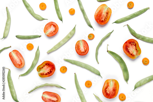 Creative layout made of haricot, tomatoes, carrot on white background .Flat lay, top view, copy space. Food concept.