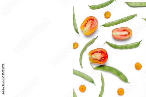 Creative layout made of haricot, tomatoes, carrot on white background .Flat lay, top view, copy space. Food concept.