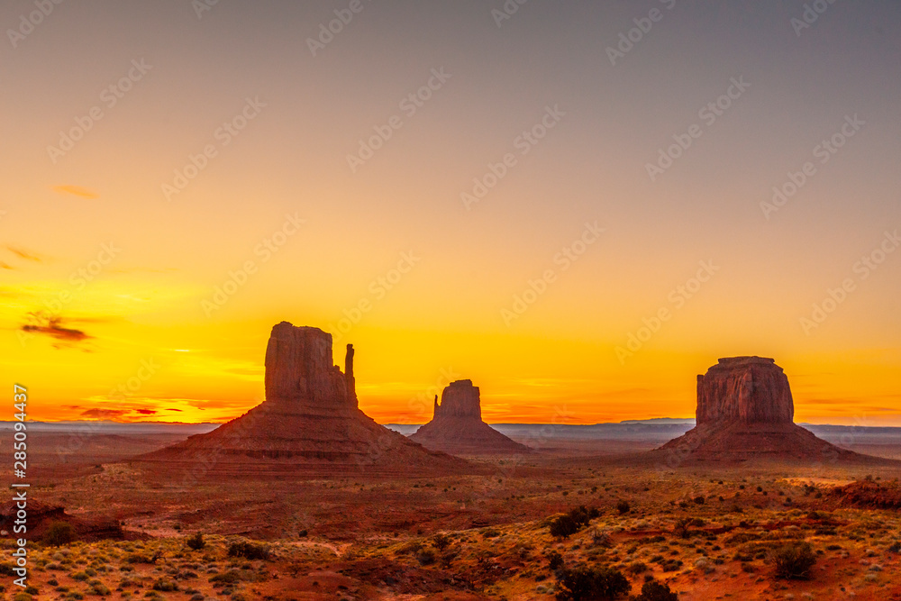 Red and cloudless Dawn begins in beautiful Monument Valley, Utah