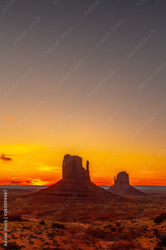 Red sunrise in the beautiful Monument Valley, Utah. Vertical photo