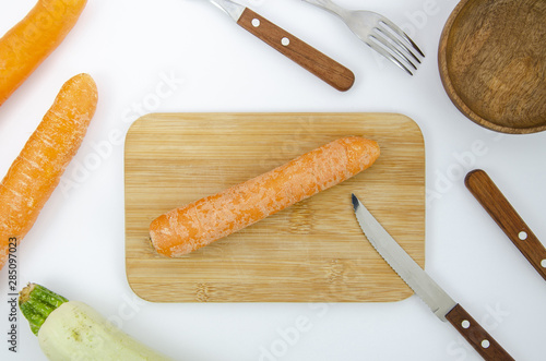 Flat lay arrangement with carrot on cutting board photo