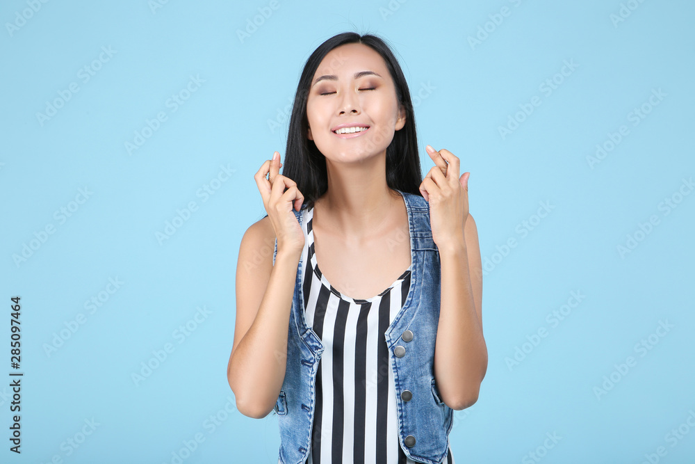 Fototapeta premium Beautiful young woman on blue background