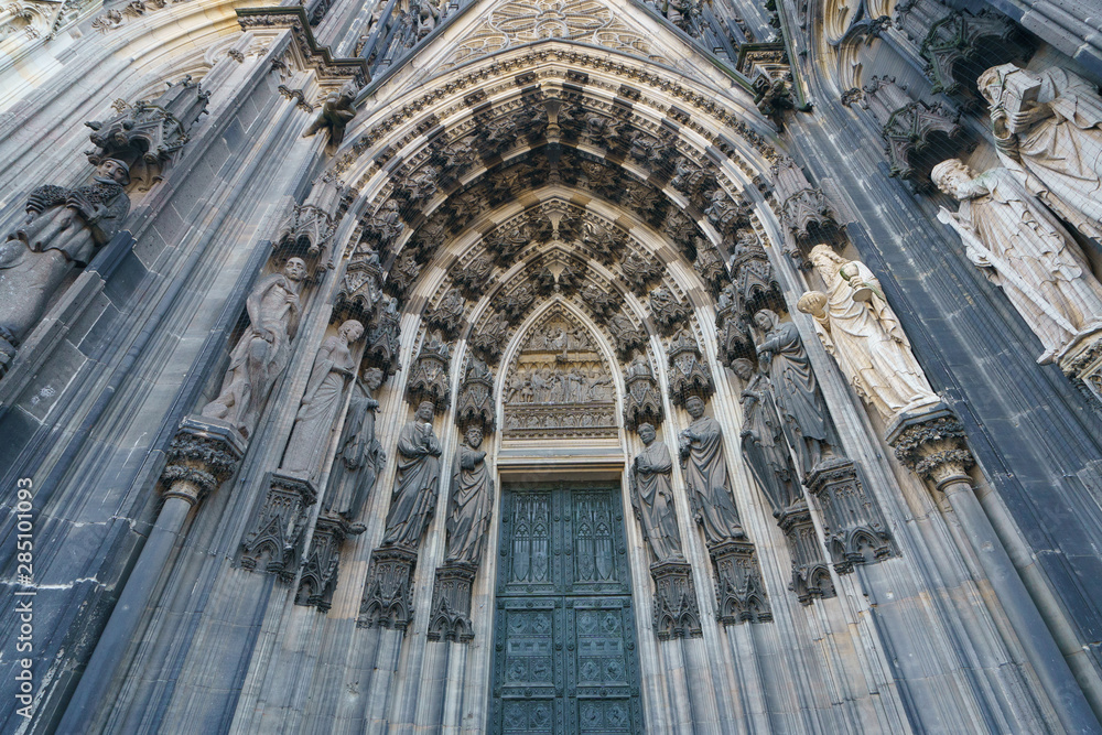 Exterior of entrance into gothic Cologne Cathedral of Saint Peter.