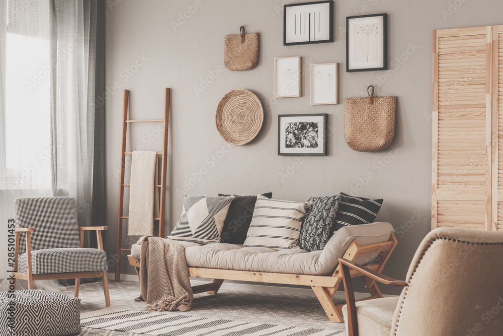 Obraz na płótnie Beige scandinavian settee with patterned pillows in stylish living room interior w salonie