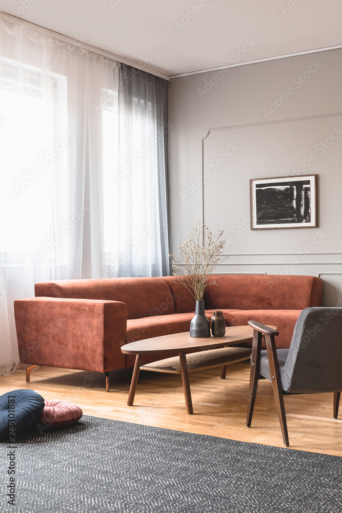 Fototapeta premium Trendy vintage armchair in stylish scandinavian living room interior with grey wall