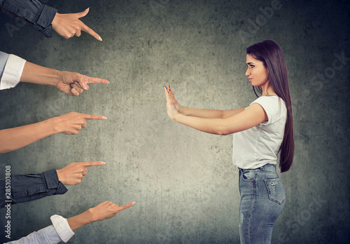 woman defending herself from blaming people with pointing fingers at her photo