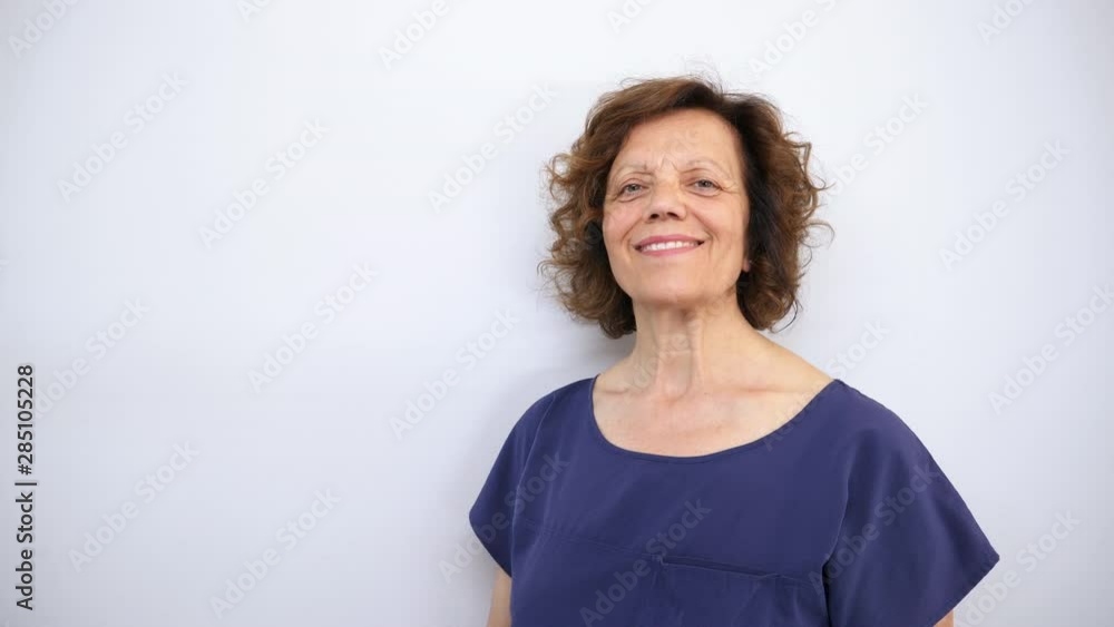 Middle aged woman showing product at side, white background Middle aged woman showing product at side, white background
