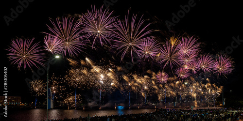 Magnificent fireworks over Daugava river to celebrate Riga City Festival. Long exposure. Panoramic view..