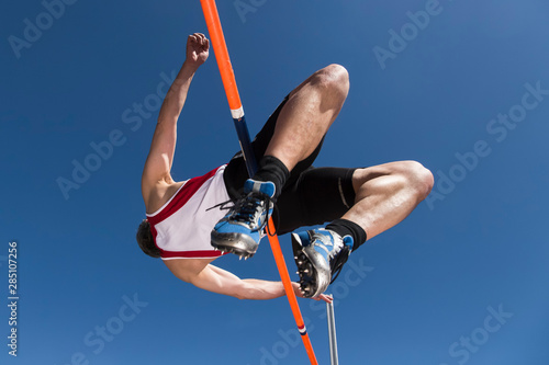 Germany, Mature man curling over high jump