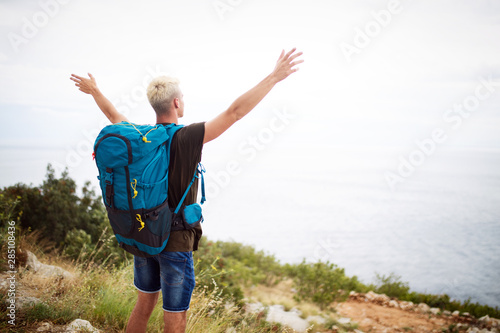 Traveler man with backpack landscape on background. Travel, happy, summer, vacations concept.