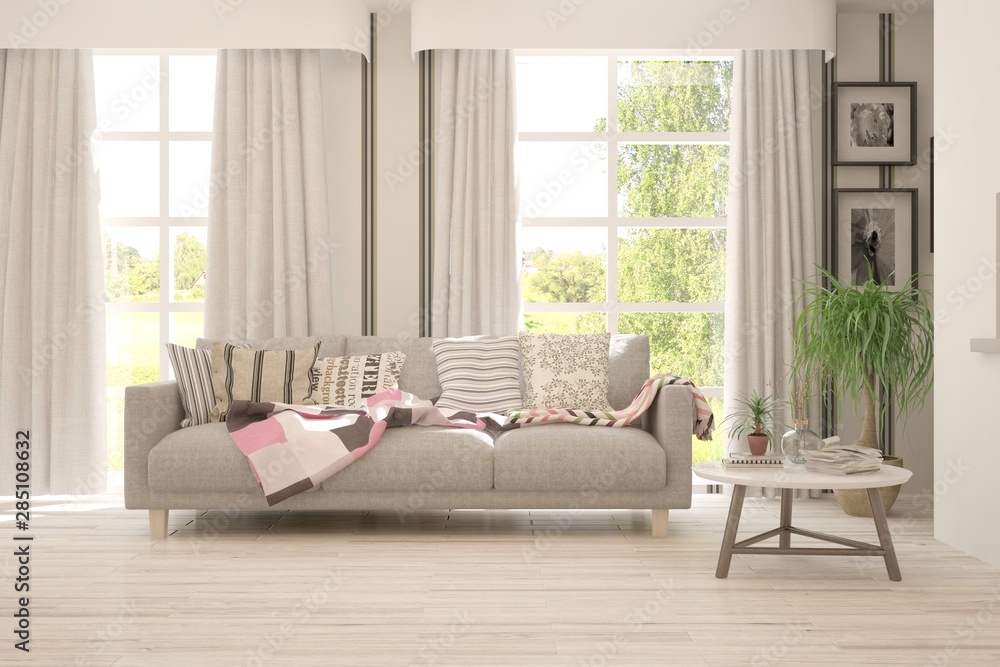 Fototapeta premium Stylish room in white color with sofa and summer landscape in window. Scandinavian interior design. 3D illustration