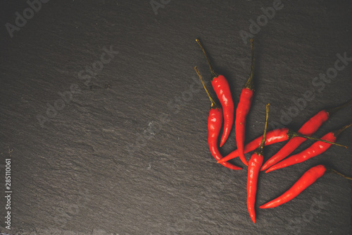 Chillies on slate, stone grunge texture. Vintage tone. Food Copy Space