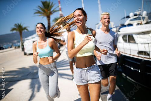 Friends running fitness training together outdoors living active healthy © NDABCREATIVITY