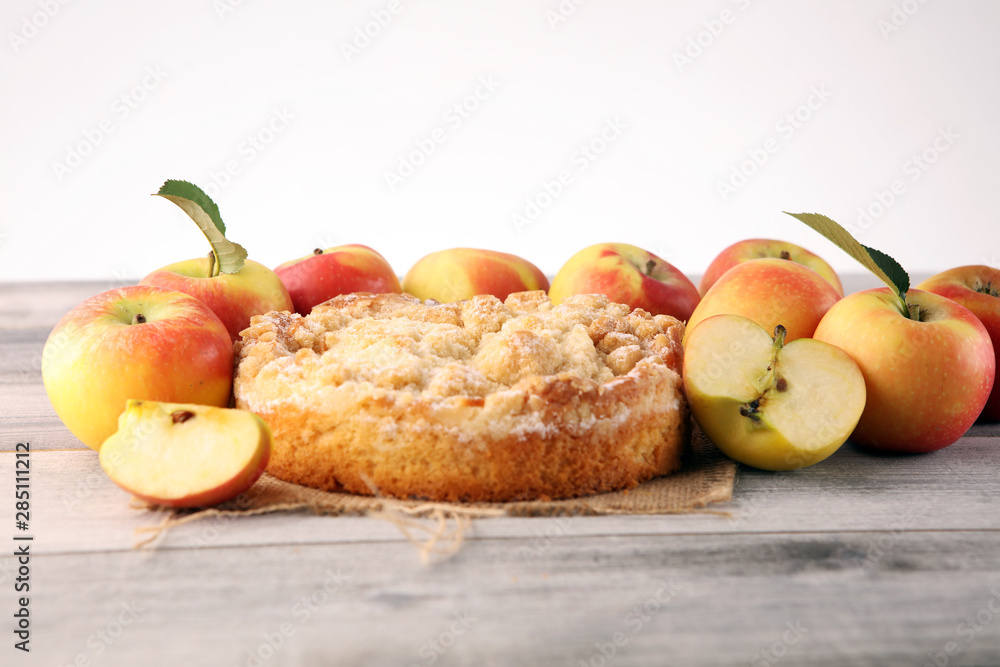 Apple pie or homemade cake with apples on wood. Delicous dessert apple tart Apple pie or homemade cake with apples on wood. Delicous dessert apple tart