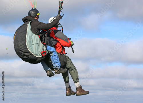 Tandem paraglider flying 