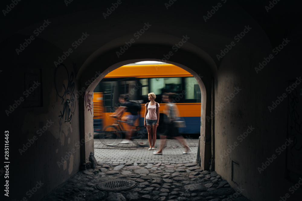 Anonymous female standing behind arch Anonymous female standing behind arch