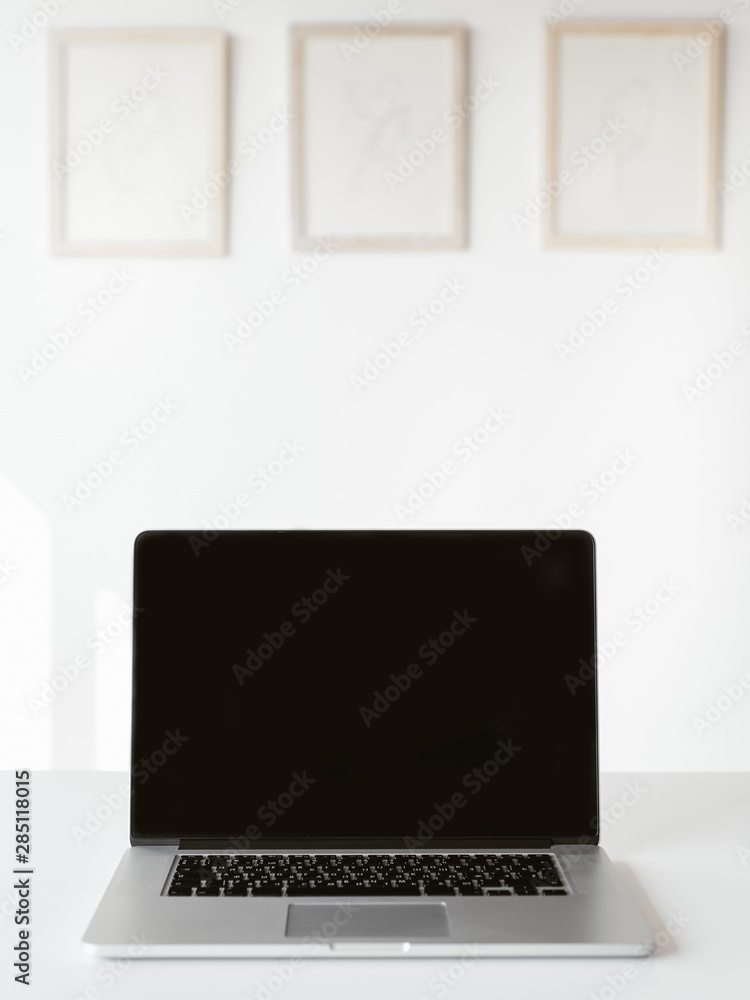 Laptop with empty display on table Laptop with empty display on table