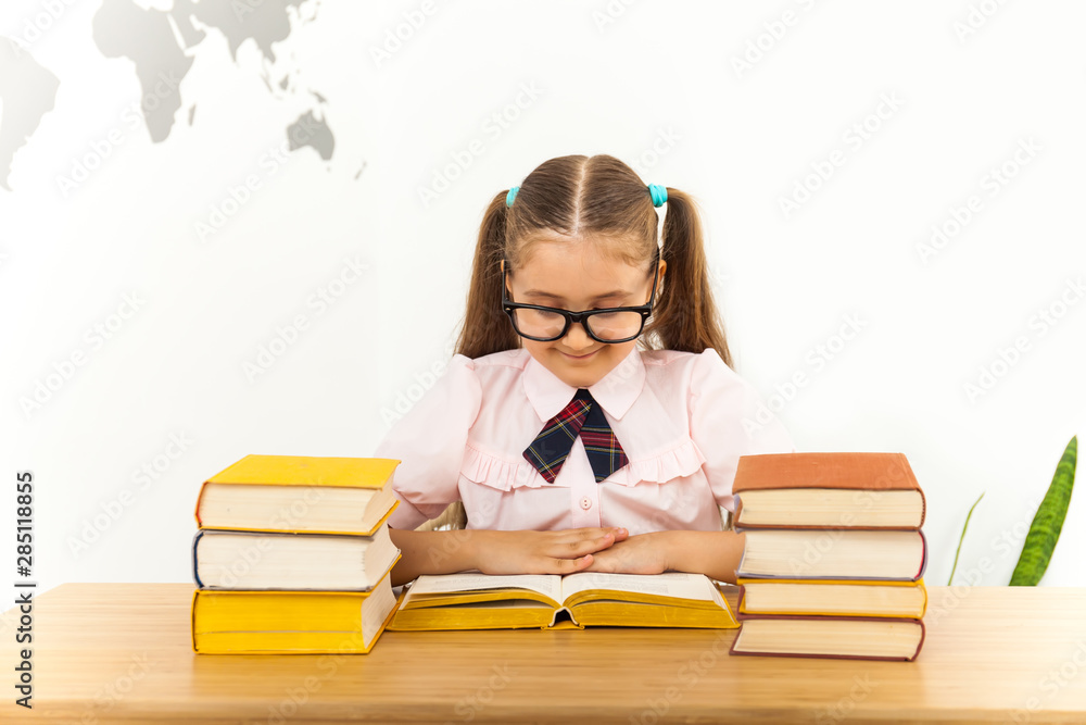 Smiling little student girl with many books at school Smiling little student girl with many books at school
