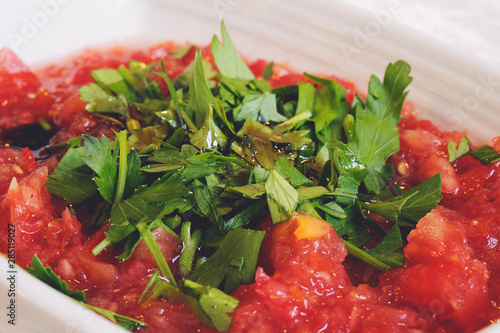 Acili ezme - turkish salad with fresh tomatos, parsley, greens, olive oil and spice. Selective focus photo