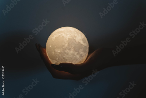 A woman holding a moon
