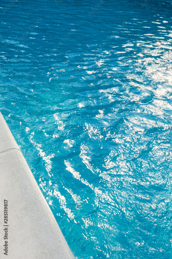 closeup of swimingpool with clean blue water summer background