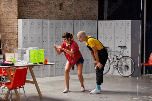 Man Standing With Classmate Photographing Project