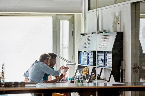 Teacher Assisting Student In Electronic Project photo