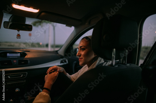 muslim woman in the car at night photo