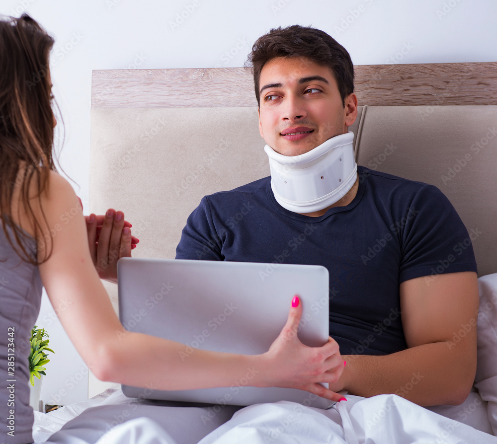 Loving wife taking care of injured husband in bed Loving wife taking care of injured husband in bed
