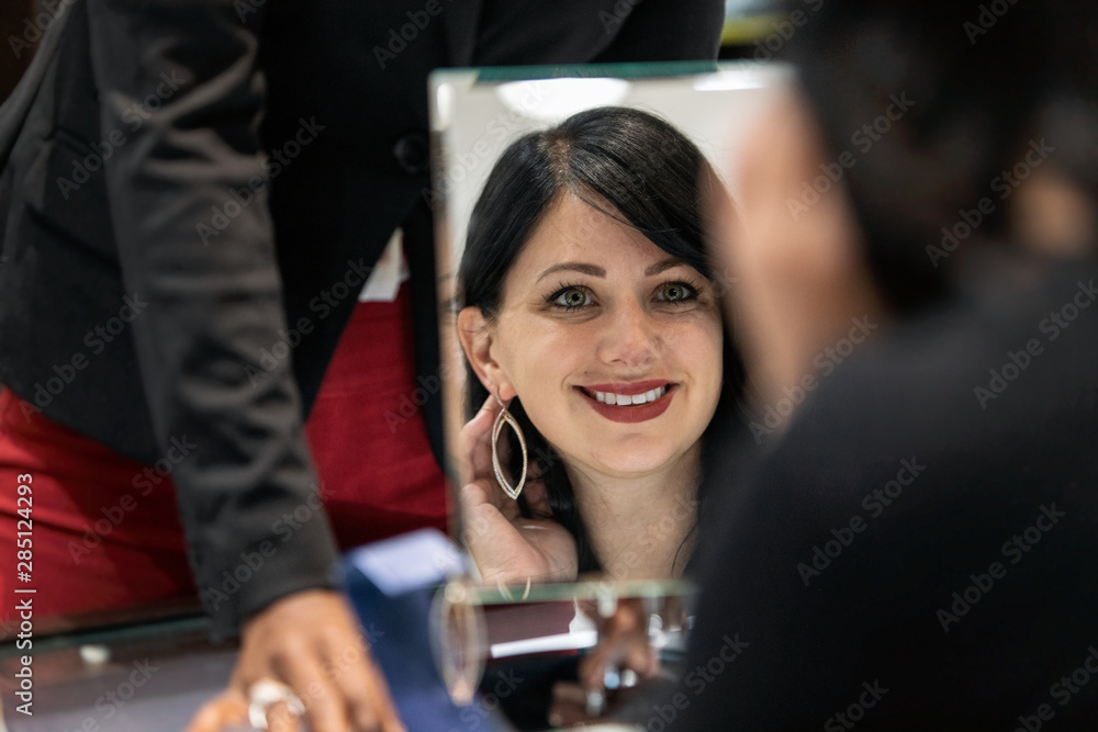 Jewelry: Woman Checking Reflection Of Earrings In Mirror Jewelry: Woman Checking Reflection Of Earrings In Mirror