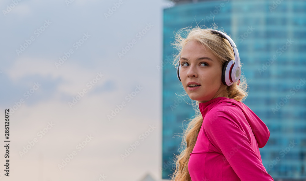 Young fitness sport woman listening music running jogging in city street.
