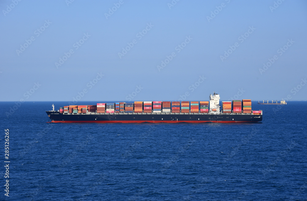 Fototapeta premium Cargo container ship loaded with containers during her voyage through the ocean. 